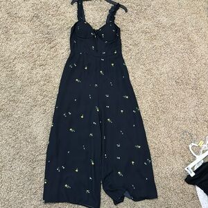 Black jumper with white and yellow flowers